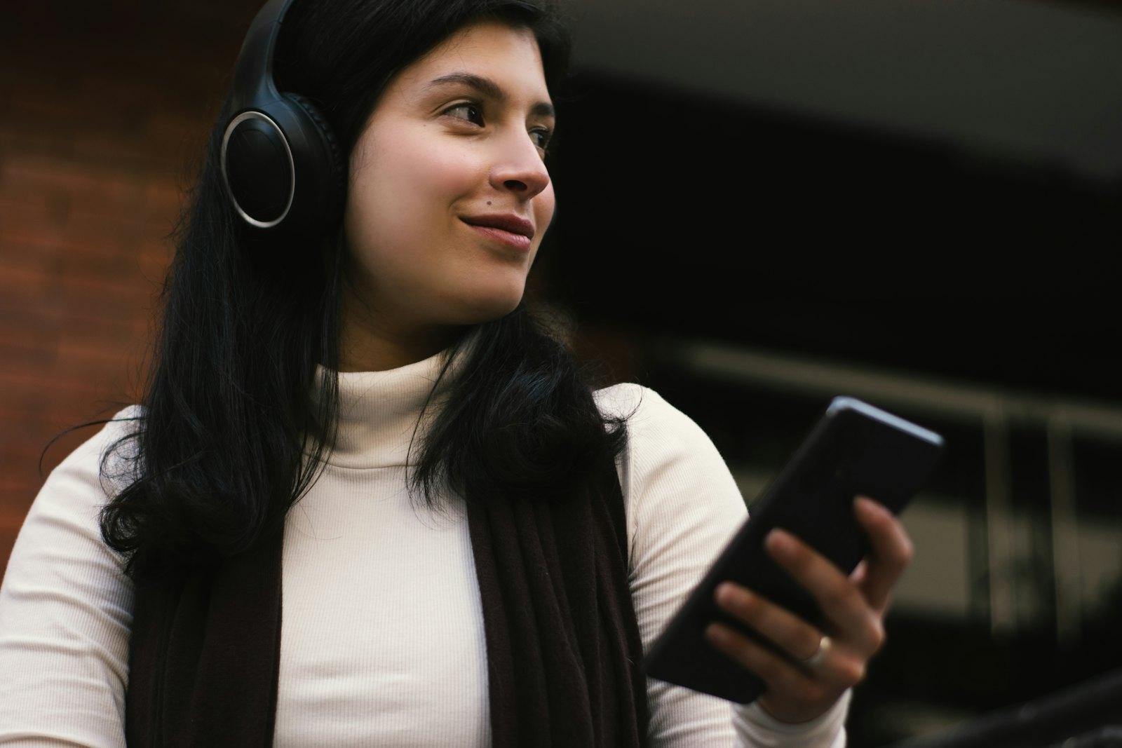 Woman with headphones replying to a message